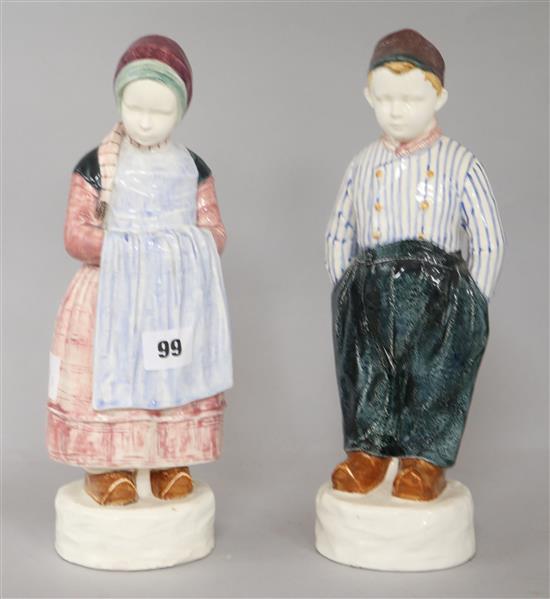 A pair of pottery figures of a Dutch boy and girl